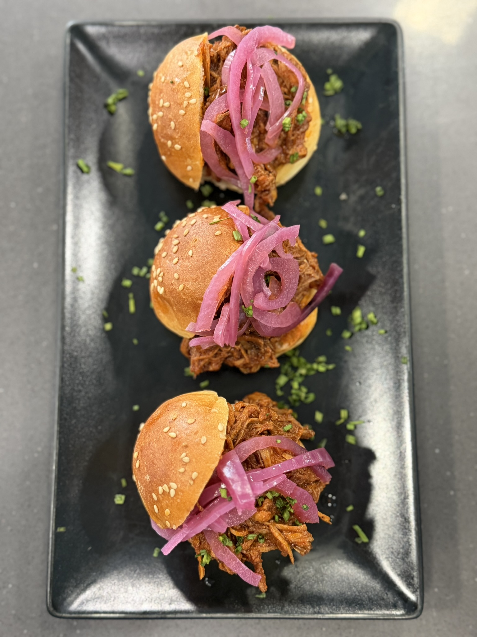 Pulled-meat sliders with pickled onion