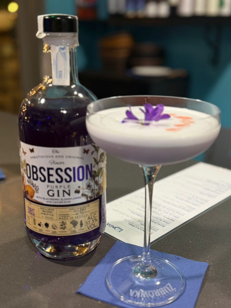 Purple gin coupe with violet flower